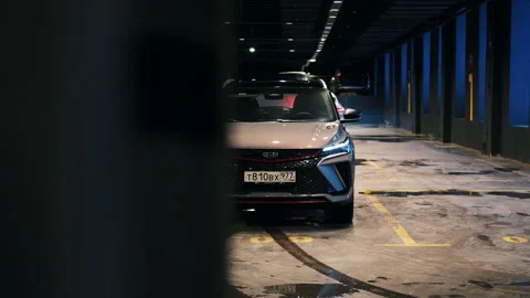 A stunning gray Geely Coolray car rests in a spacious parking garage, its sleek Stock Footage 263313826