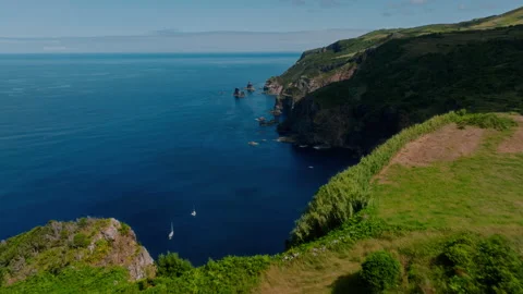 Stunning high-angle aerial drone view of two lonely sailboats anchored in a deep 库存影片 335710611