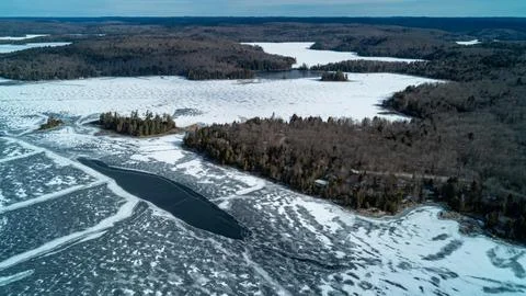 A stunning high-angle panoramic drone photograph looking over a dense winter  Foto stock