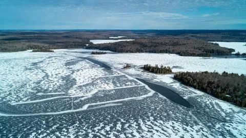 A stunning high-angle panoramic drone photograph looking over a dense winter  Stock Photos