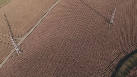 Stunning high-voltage power lines and a straight dirt road traversing a vas.. Stock Footage 336835847