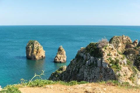 A stunning horizontal view of iconic limestone sea stacks rising from the t.. Stock Photos