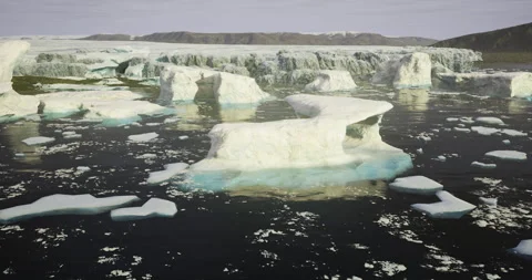 Stunning icebergs float in calm arctic waters under a clear sky Vídeos de archivo 310655043