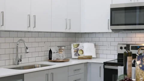 Stunning interiors of exquisite kitchen completed with new furniture, delicate Stock Footage 242942159