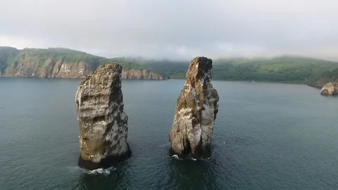 Stunning Kamchatka Peninsula seascape: top view Three Brothers Rocks Stock Footage