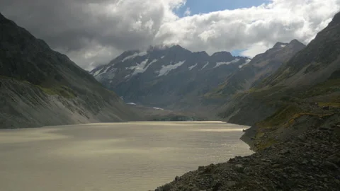Stunning lake surrounded by mountains on a cloudy day, in New Zealand Stock Footage 217400152
