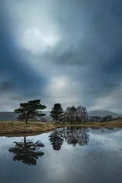 Stunning landscape image of dramatic storm clouds over Kelly Hall Tarn in Lak Stock Photos