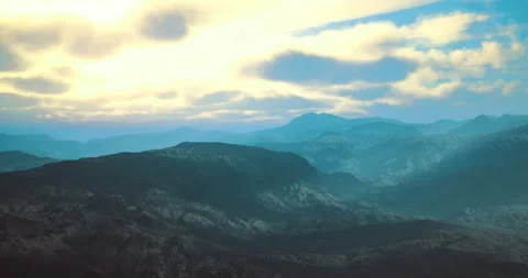 Stunning landscape of mountains under a dramatic sunset sky in soft hues Stock Footage 315656397