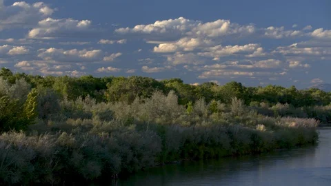 Stunning left to right pan of Rio Grande river at dusk with desert mountains. Stock Footage 126995764