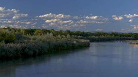Stunning left to right pan of Rio Grande river at dusk with Canada geese flying. Stock Footage 127005747