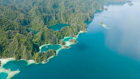 Stunning limestone formations rise above the water. Coron, Palawan, Philippines. Stock Footage 317524726