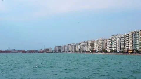Stunning low angle steady shot of crowded modern hotel villas sea front quay of Stock Footage 94923649