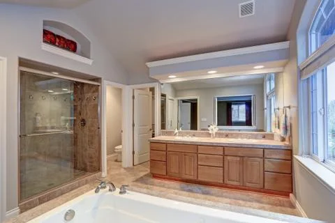 Stunning master bathroom with double vanity cabinet, large arched window, vau Stock Photos