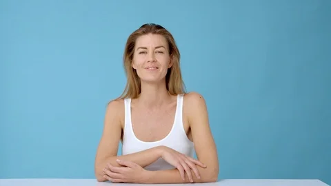 Stunning Model with Gradient Glowing Skin Sitting on a Chair Posing and Smiling Stock Footage 117629152