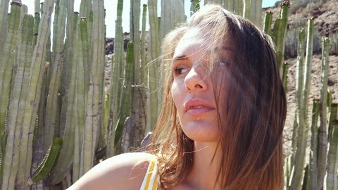 Stunning Model Looking Sideways with Cacti in the Background 스톡 동영상 112022159