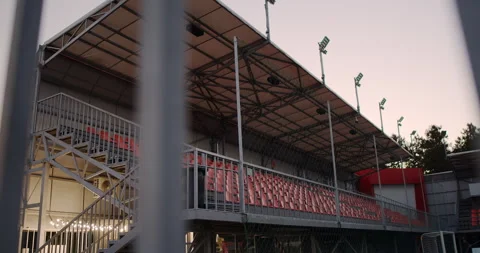 A stunning modern stadium view at dusk, showcasing illuminated seating and Stock Footage 317979196