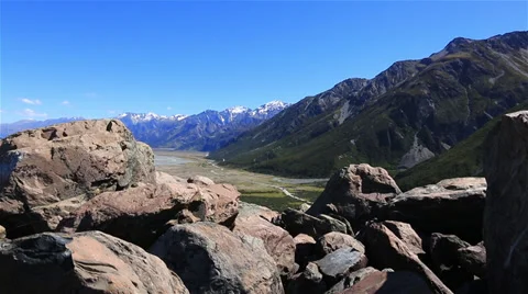 Stunning mountains with large rocks in the foreground - New Zealand. Stock Footage 34343050