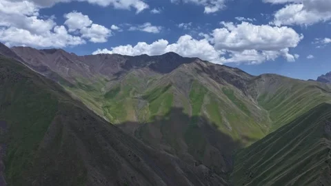 Stunning mountains in remote wilderness under sunny clouds, aerial hyper lapse Stock Footage 327616467
