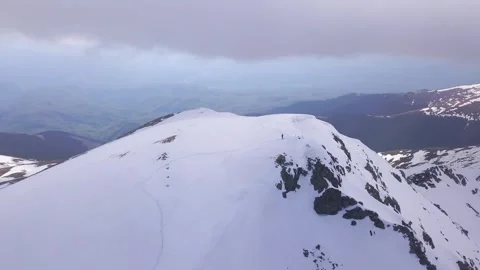 Stunning mountaintop view. Peak covered in fresh snow with lone climber at Video stock 247178565