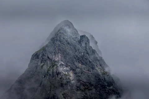 A stunning, mysterious peak shrouded in mist at Rila mountain in Bulgaria. Ma Stock Photos
