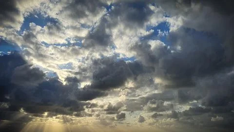 A stunning natural background showcasing dramatic clouds illuminated by the.. Illustrazione stock