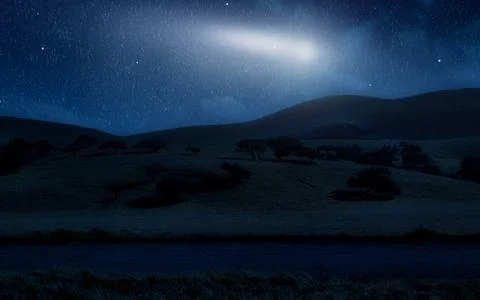 Stunning Night Sky Over Rolling Hills With Comet Streaking Across The Darknes Stock Photos