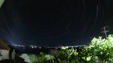 Stunning Night Sky Star Trails Time Lapse Creating Circular Pattern Over City Video stock 322192425