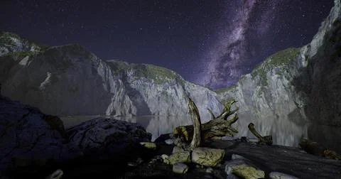 Stunning night view of cliffs under a starry sky at a serene lake Stock Illustration