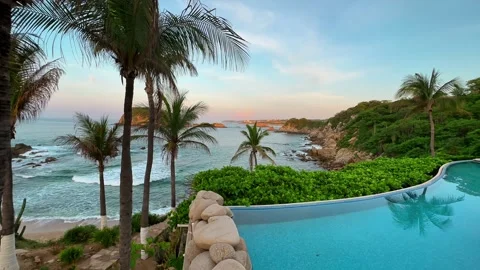 Stunning Ocean View with Cliffs, Palm Trees, and Infinity Pool Stock Footage 327449459