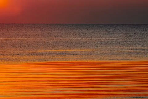 A stunning ocean view at sunset with deep blue waters and a sky Stock Photos