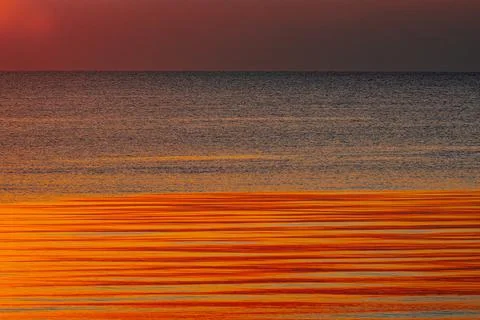 A stunning ocean view at sunset with deep blue waters and a sky Stock Photos