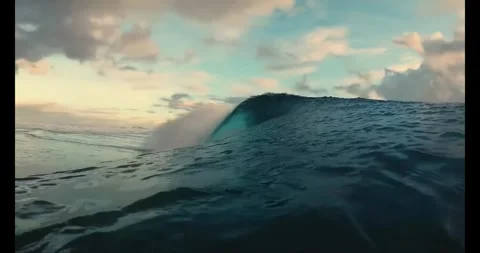 Stunning ocean wave rolling over with beautiful blue turquoise water and sky Stock Footage 318175362