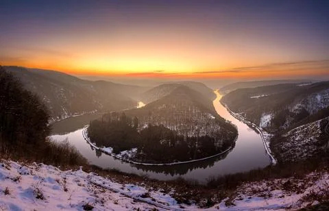 A stunning panoramic view of a river winding through a snow-dusted valley a.. Stock Photos