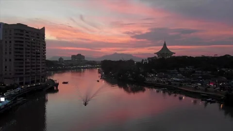 Stunning Pink Sunset Reflects Over Kuching Waterfront and Sarawak River Видео 332810778