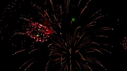 Stunning red fireworks display lighting up the night sky during a festive Video stock 337464304