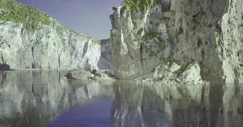 Stunning reflections of cliffs along a tranquil body of water in nature Stock Illustration