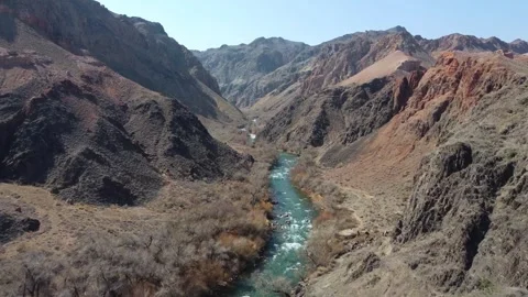 Stunning river flow in a deep mountain gorge. Morning light, Central Asia Stock Footage 332690815