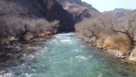 Stunning river flow in a deep mountain gorge. Morning light, Central Asia Stock Footage 332690839