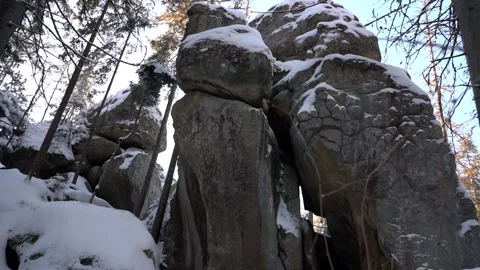 Stunning rock formations in a snowy forest landscape during winter Stock Footage 290785679