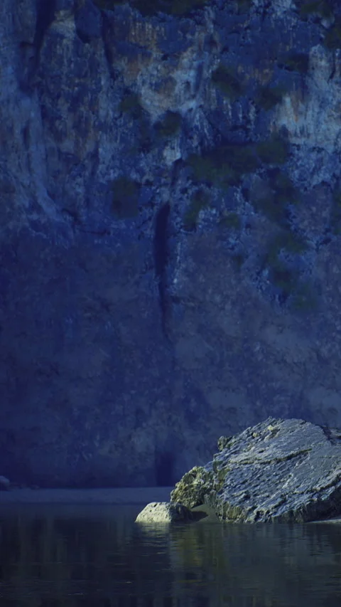 A stunning rock stands alone in calm waters as dusk settles around it 스톡 동영상 334256341