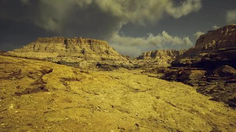 Stunning rocky landscape under a dramatic sky in a remote desert Stock Illustration