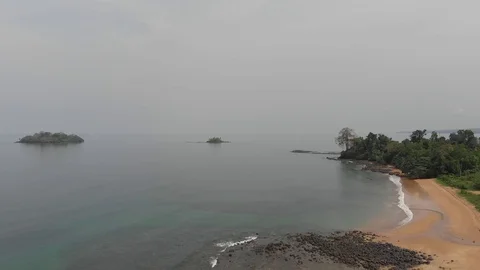 Stunning sandy beach surrounded by equatorial forest, Equatorial Guinea Stock Footage 129940410