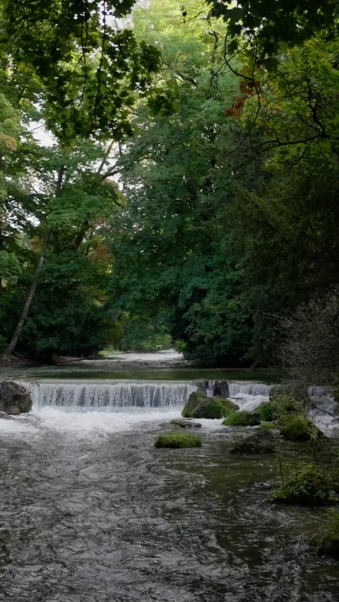 A stunning scenic view of a serene waterfall gracefully framed by ornate Stock Footage 320138448