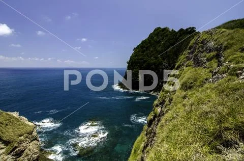 Stunning seascape from the cliff top at sunny day.Blue sky background and wav Stock Photos
