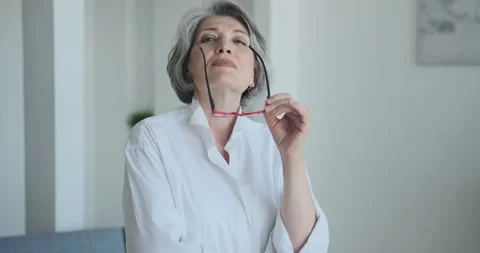 A stunning, self-assured elderly lady engineer removes her spectacles and looks Stock Footage 159977817