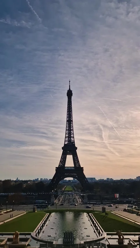 Stunning silhouette of the Eiffel Tower in Paris against a hazy sunset sky, with Stock Footage 325048189