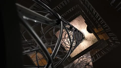 A stunning spiral staircase viewed from above, illuminated by warm lighting. The Stock Footage 296532780