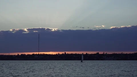Stunning steady view on warm orange evening sunset cloudy sky over small boat Stock Footage 94822677