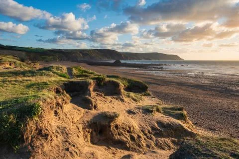 Stunning Summer sunset landscape image of Widemouth Bay in Devon England with Stock Photos