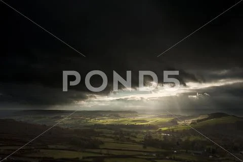 Stunning sun beams over big moor in peak district national park england Stock Photos